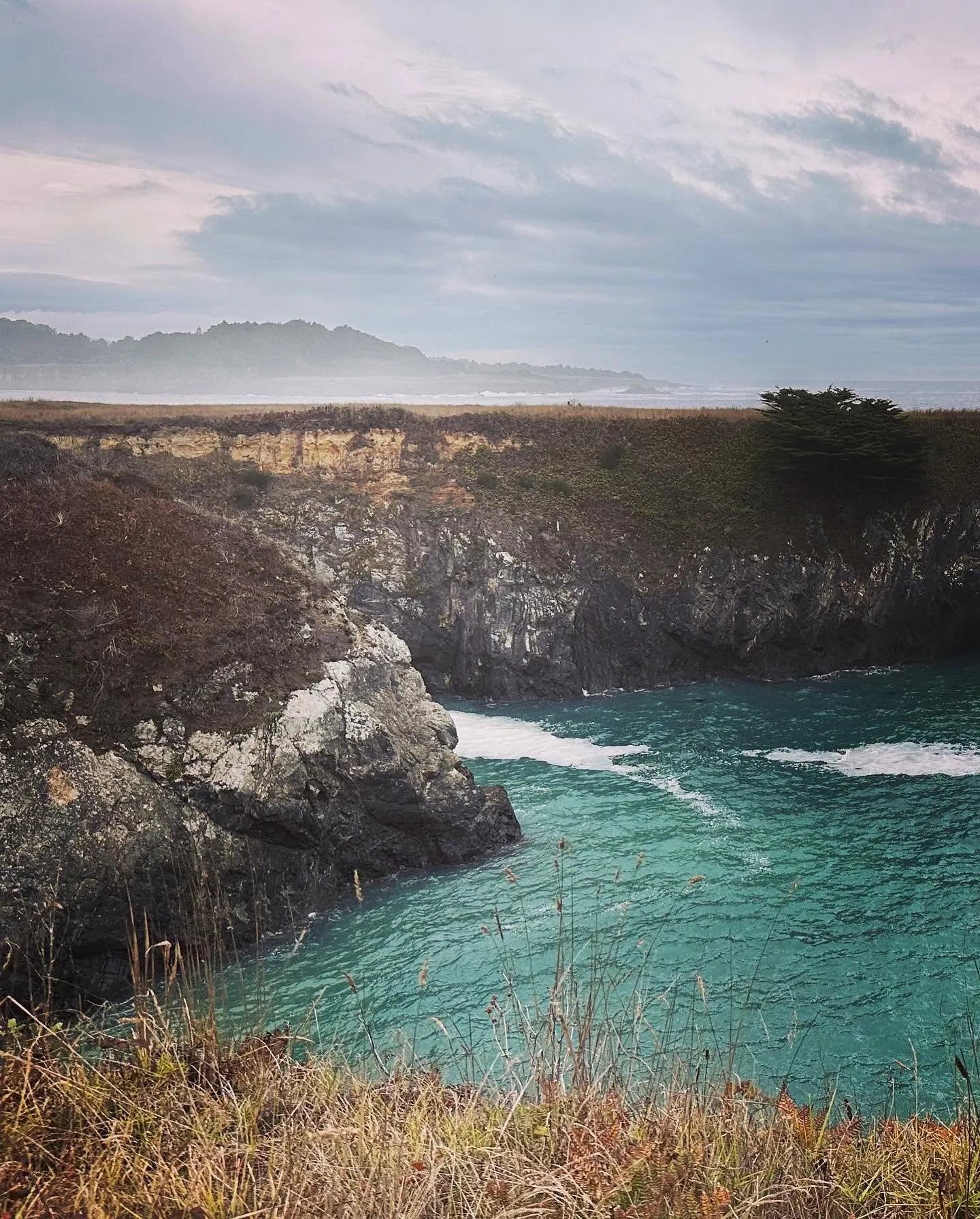 Turquoise cove beneath coastal cliffs