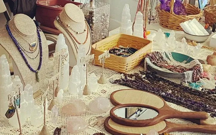Necklaces on small display busts among white crystal towers